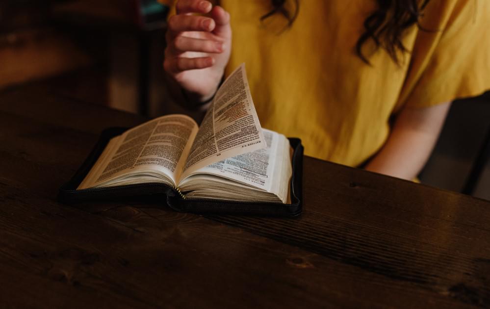 Woman Flipping Bible Pages