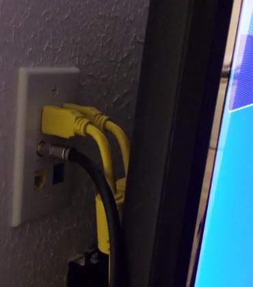 Wall plate with HDMI, coax, and network behind a television